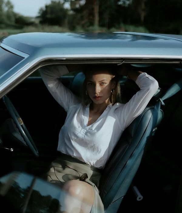 Woman sitting peacefully after exercise, looking calm and relaxed.
